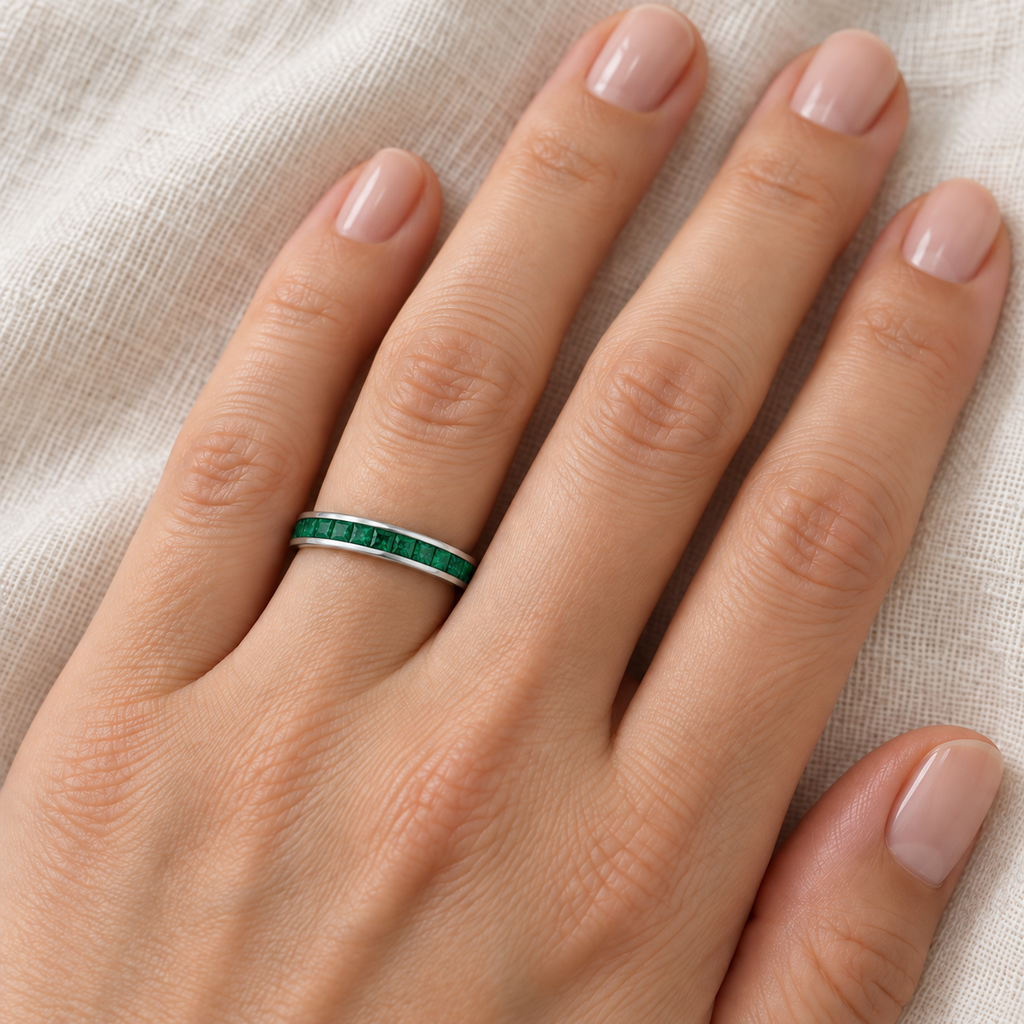 Natural emerald princess-cut 3 mm eternity band in 14k white gold — ivory linen close-up