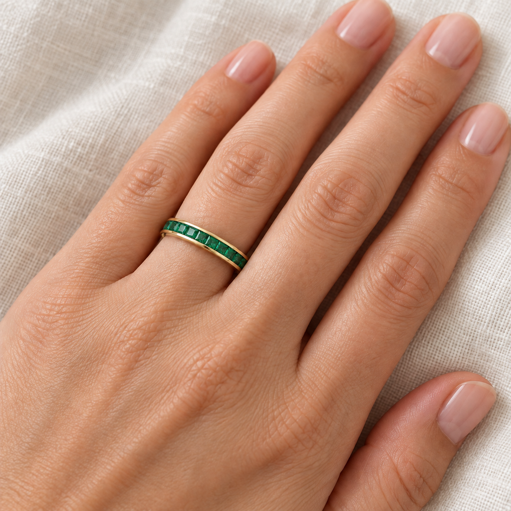 Lab emerald princess-cut 3 mm eternity band in 14k yellow gold — ivory linen close-up