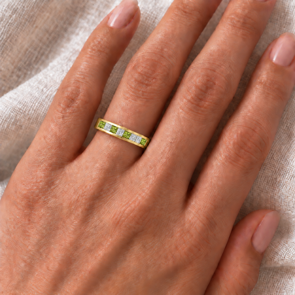 Peridot and lab-grown diamond band in 14K yellow gold, 4mm, five princess-cut peridot and four princess-cut lab-grown diamonds, 0.73ct total — ivory-linen hand closeup