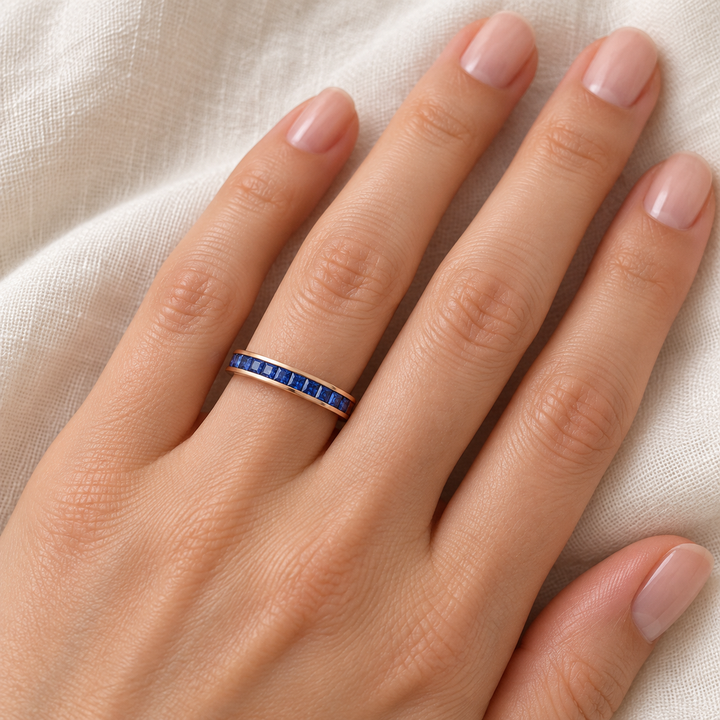 Lab-grown blue sapphire 3 mm princess-cut eternity band in 14k rose gold — ivory-linen close-up