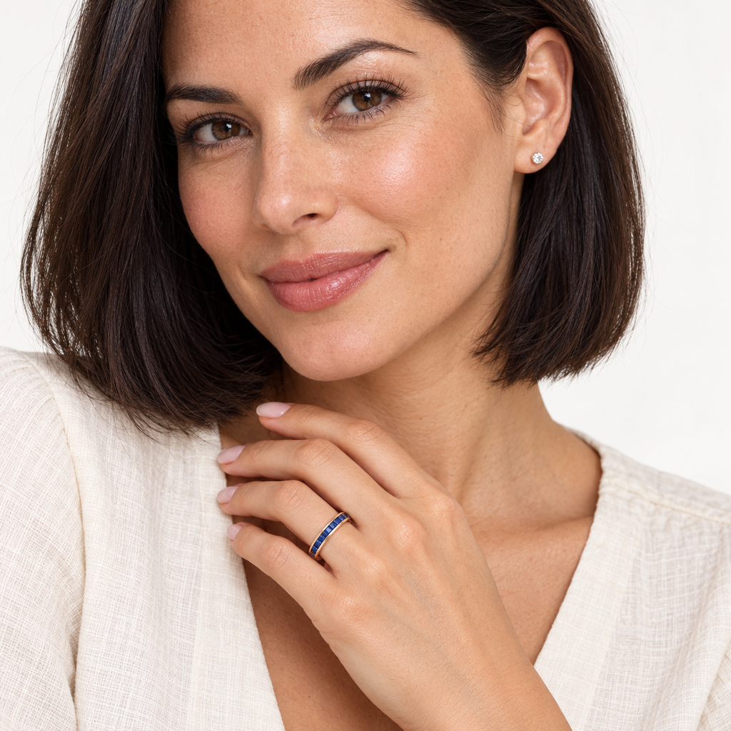 Natural blue sapphire 3 mm princess-cut eternity band in 14k rose gold — studio portrait