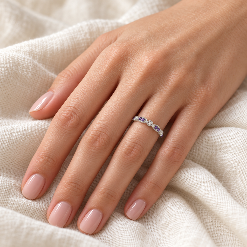 Marquise and dot natural amethyst and diamond band in 14k white gold on left hand over ivory linen