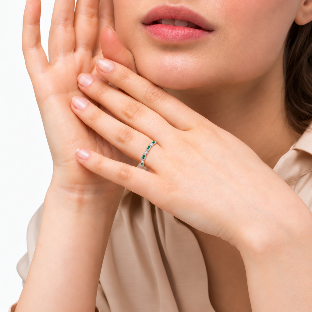 Petite natural emerald and diamond marquise band in 14k white gold, face-visible studio portrait