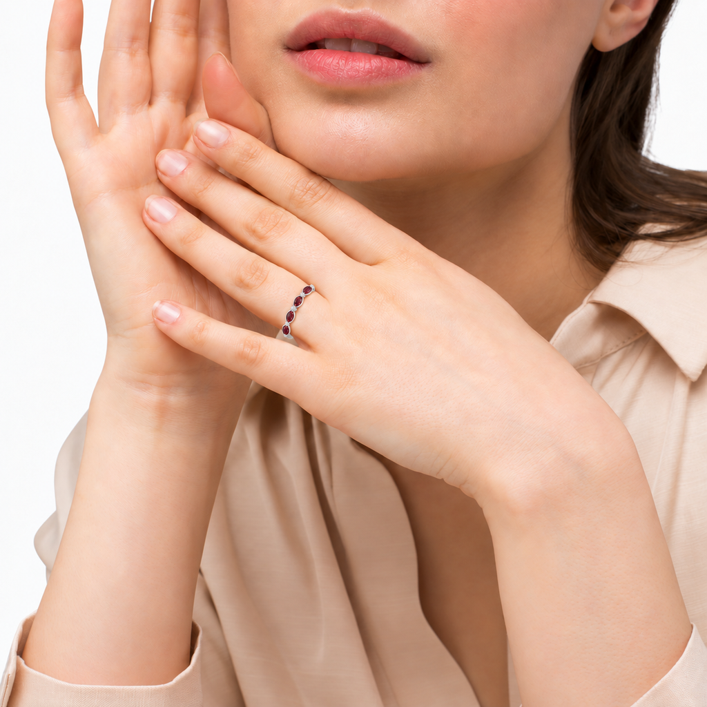 Marquise and dot natural garnet and diamond band in platinum on model in a professional studio portrait