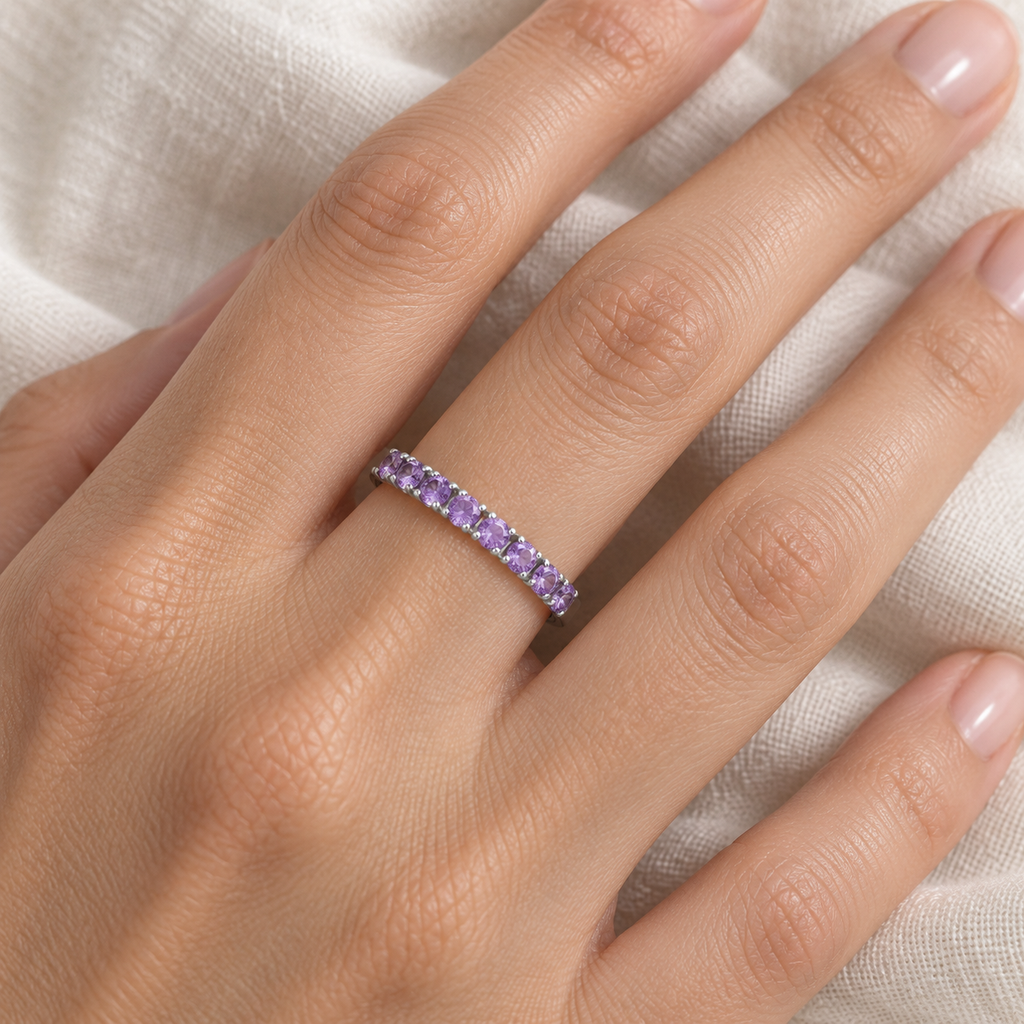 Amethyst stackable ring in 14k white gold, close-up hand view on ivory linen