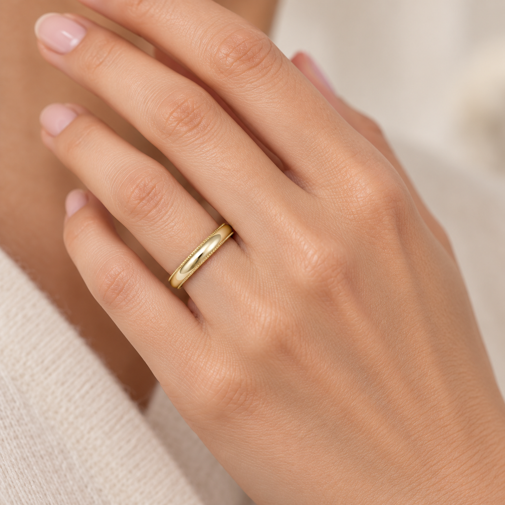 3mm 14k yellow gold milgrain wedding band on a woman's ring finger