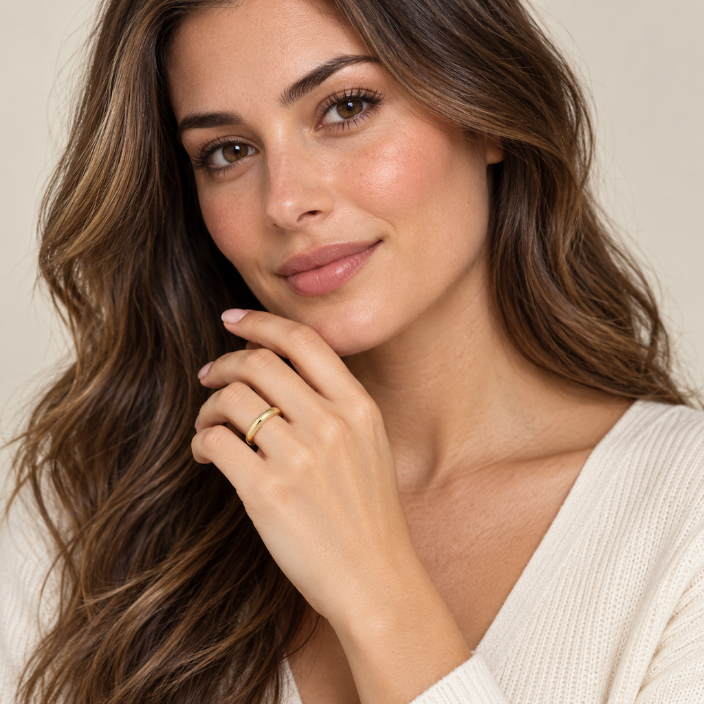 Woman wearing a 3mm 14k yellow gold milgrain wedding band