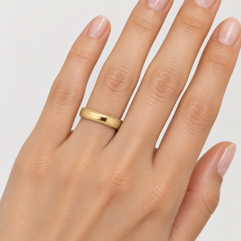 Carved Wedding Band in 14k Yellow Gold (4mm) - female hand close-up