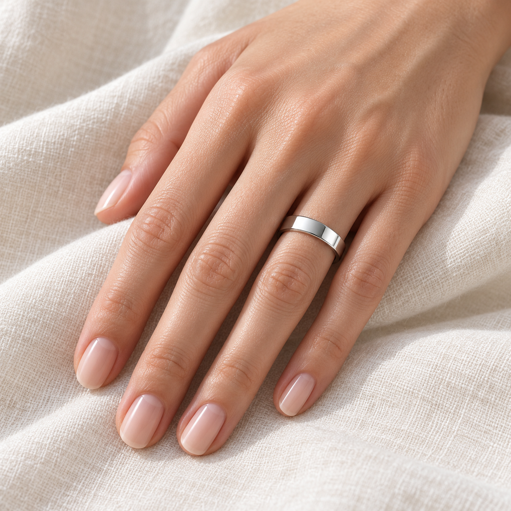 950 Palladium Wedding Band Plain Ring Flat Comfort-Fit (4 mm) - Female hand wearing wedding band