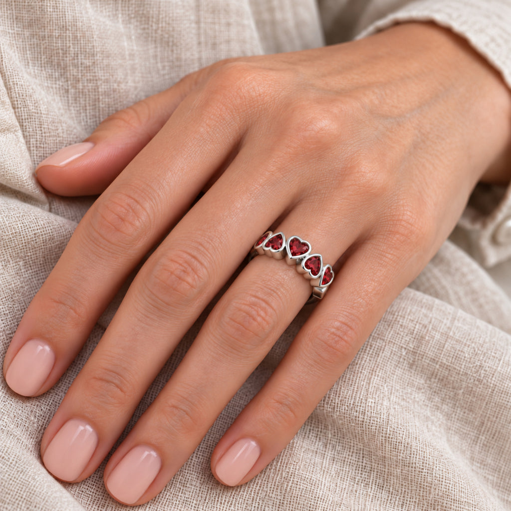 Five heart Mozambique garnet ring in Silver — close-up hand model view; approximate top 17 x 5.7 mm