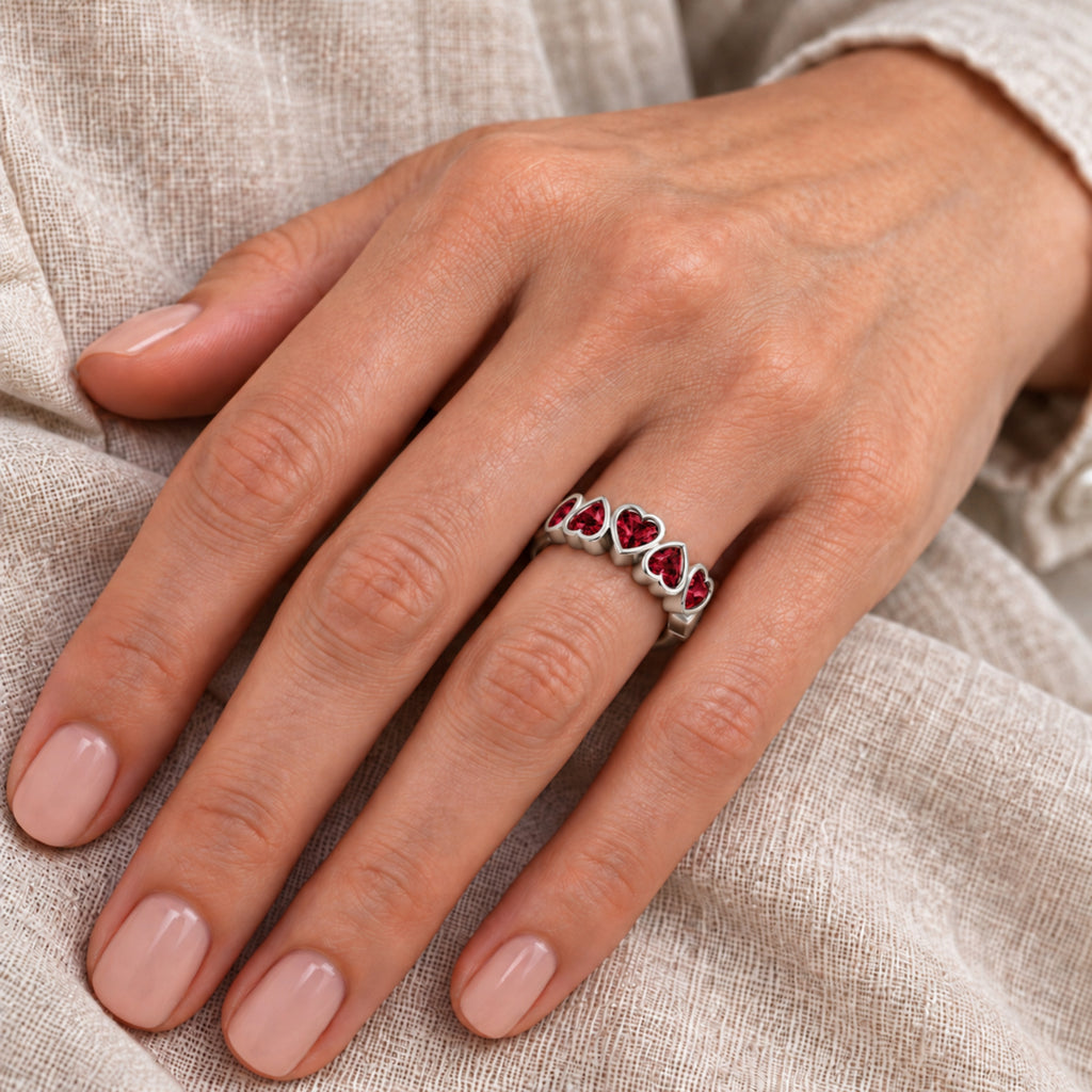 Five heart Mozambique garnet ring in WhiteGold — close-up hand model view; approximate top 17 x 5.7 mm