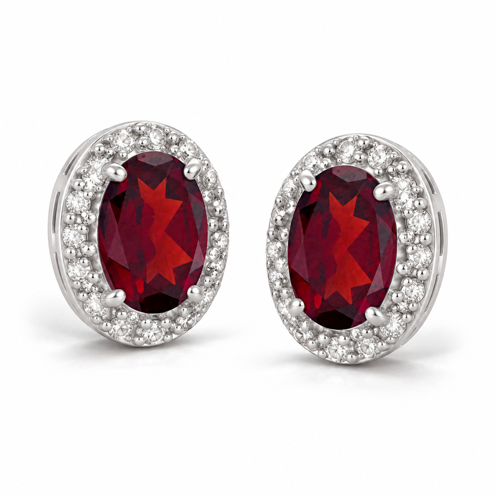 Oval ruby and diamond halo stud earrings 14K white gold, 6x4 mm center stones — angle view; illustrative scale