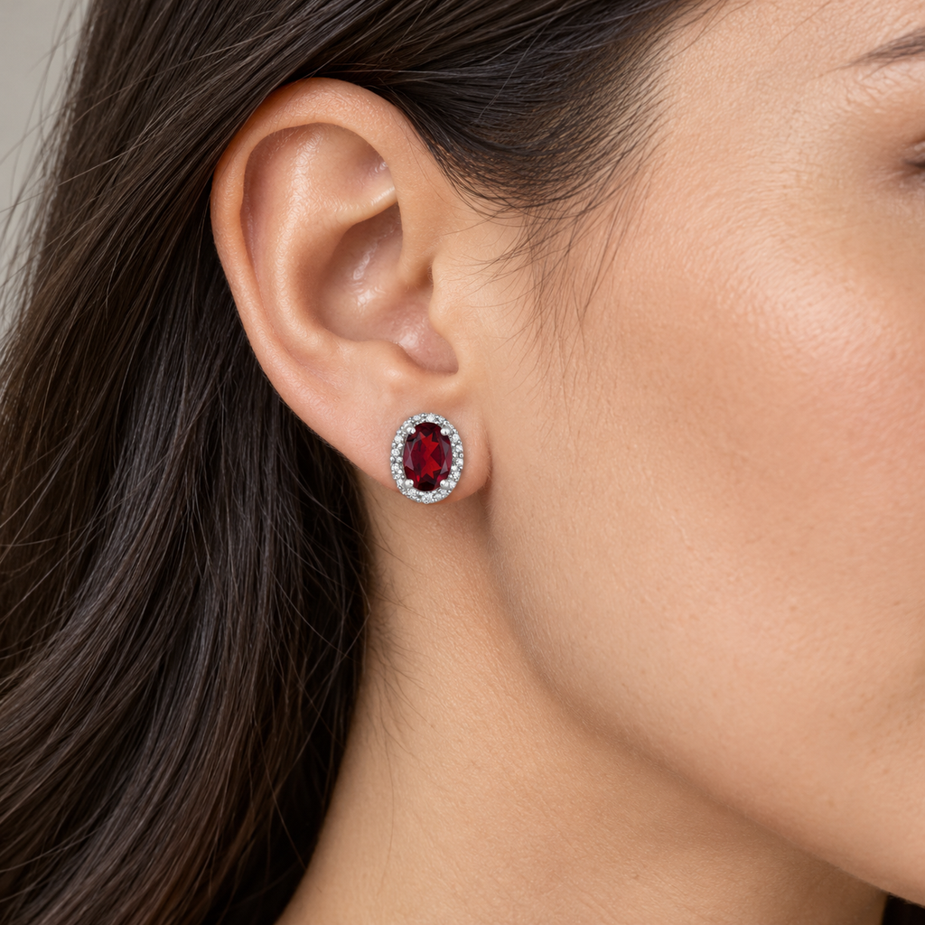 Oval ruby and diamond halo stud earrings 14K white gold, 6x4 mm center stones — close view; illustrative scale