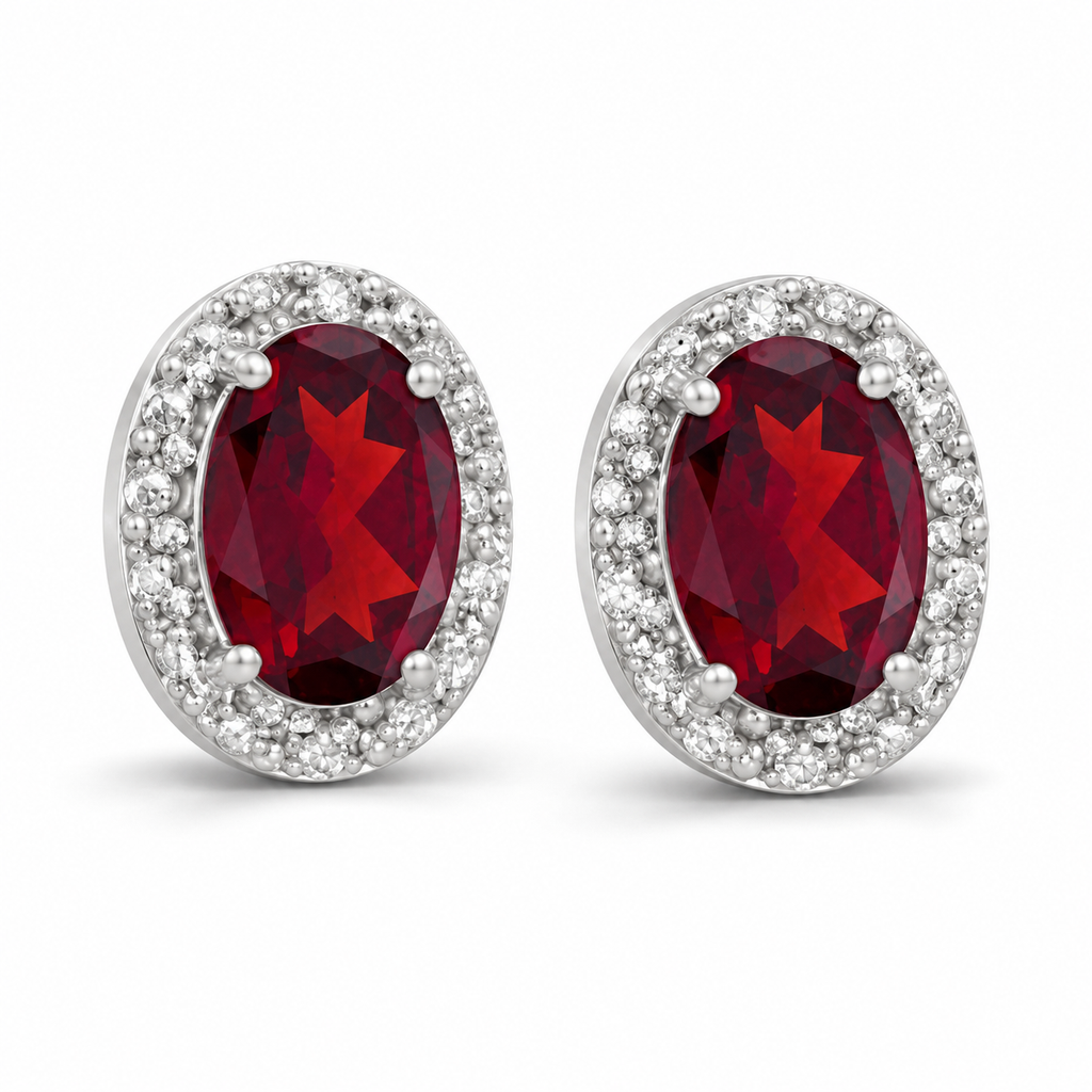 Oval ruby and diamond halo stud earrings 14K white gold, 7x5 mm center stones — angle view; illustrative scale